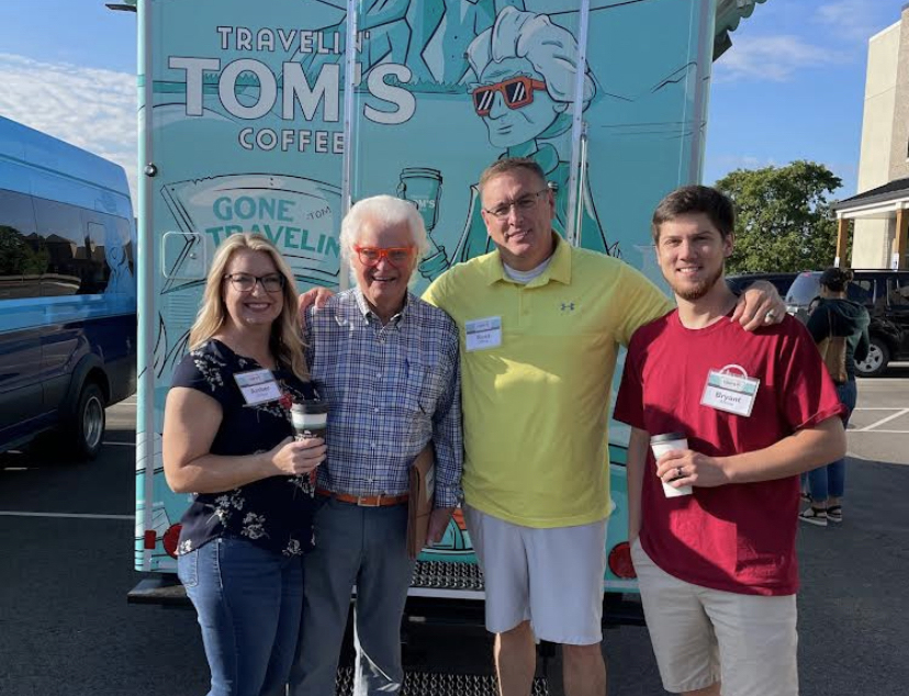 The O'Rears pose with the founder's father, Tom Lamb, in front of their franchise truck.