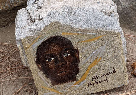 A tribute to Ahmaud Arbery on a piece of stone.