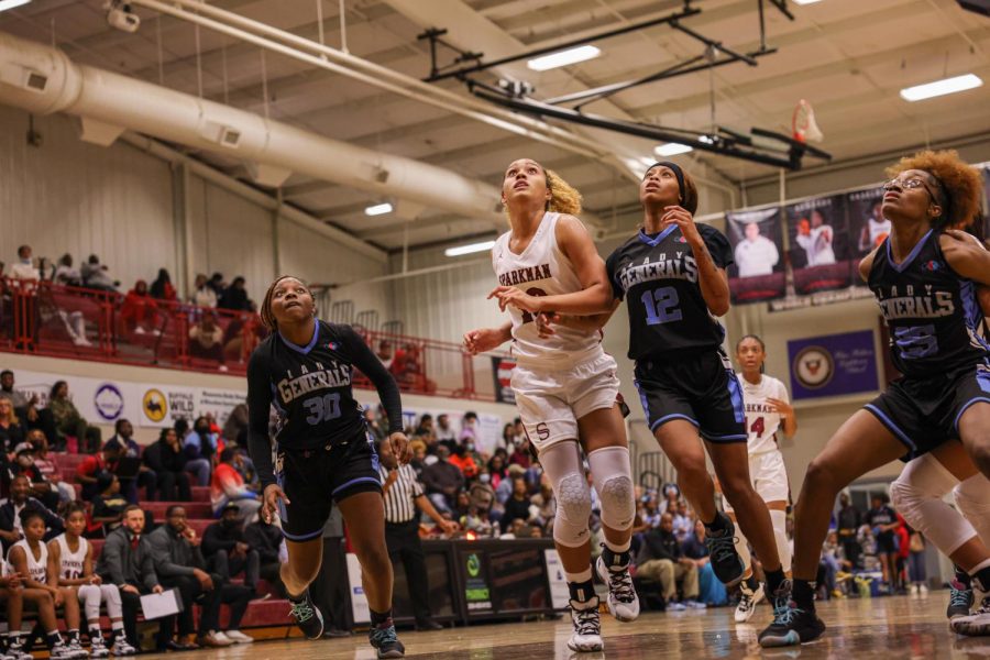 Blocking out, sophomore Jalei ONeal prepares to bounce on the rebound.