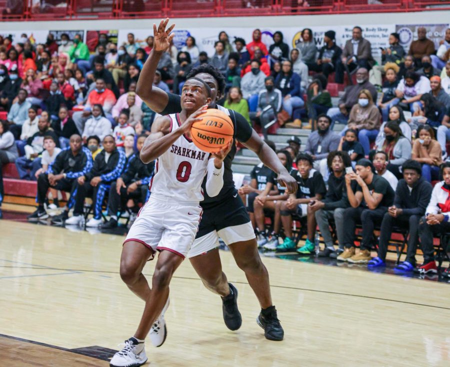 Going up for the layup, senior Calen Lightford scores two against a Lee defender. 