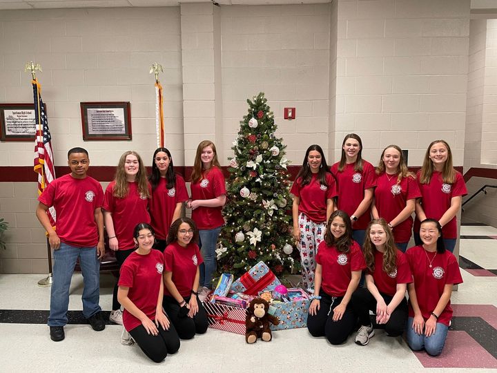 Before delivering toys to the Toys for Tots destination, members of the Junior Civitan club pose to show off their success. 