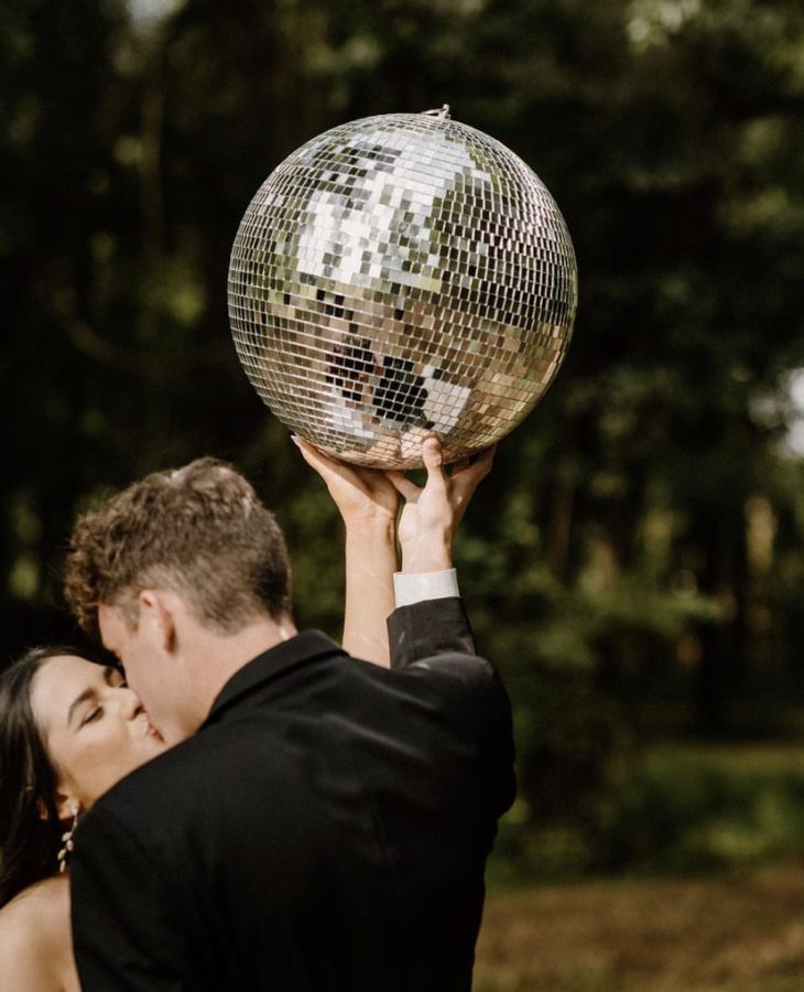 The happy couple pose with their disco ball after they tied the knot last year. 