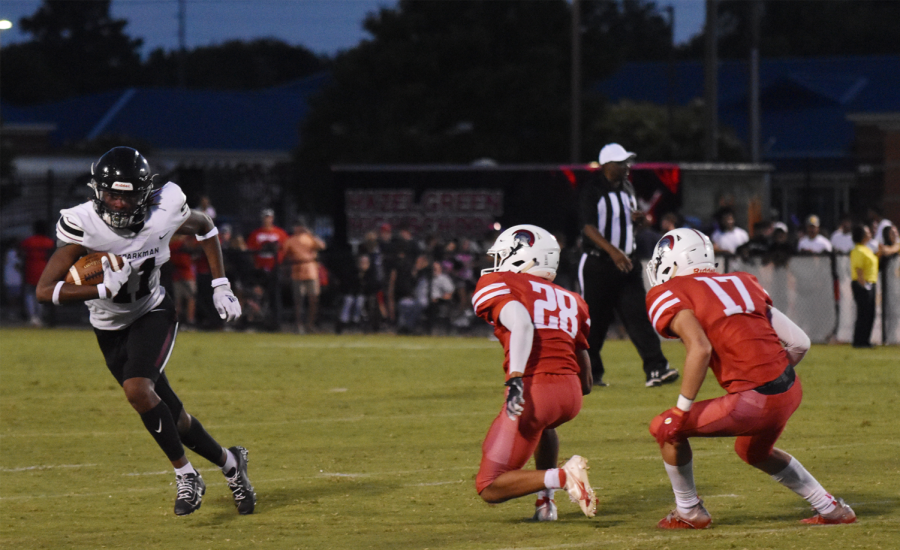 After catching the kickoff, senior Karmelo Montgomery looks upfield. 