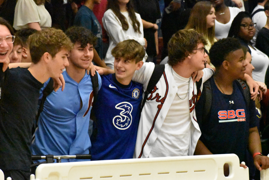 A group of junior boys link arms to sing the Alma Mater at the end of the pep rally.