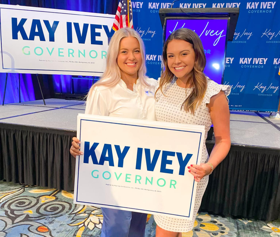 Saylor Cuzzort and a fellow intern hold up a Gov. Kay Ivey political sign at an election party. Ivey won the Republican primary and all interns were allowed to attend to celebrate. 