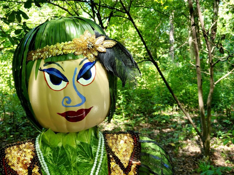 A flapper girl scarecrow graces one of the pathways at the Botanical Gardens. Patrons who create the scarecrows can choose a theme of their choice. 
