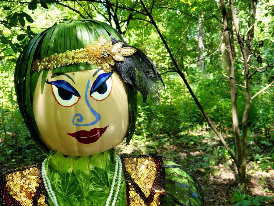 A flapper girl scarecrow graces one of the pathways at the Botanical Gardens. Patrons who create the scarecrows can choose a theme of their choice.