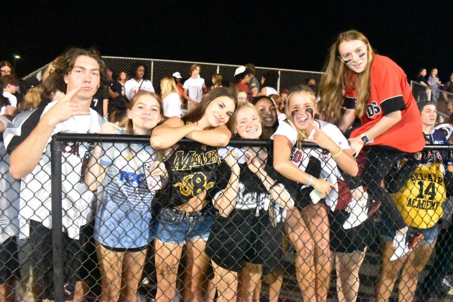 The student section poses for a photo in their game theme wear. 