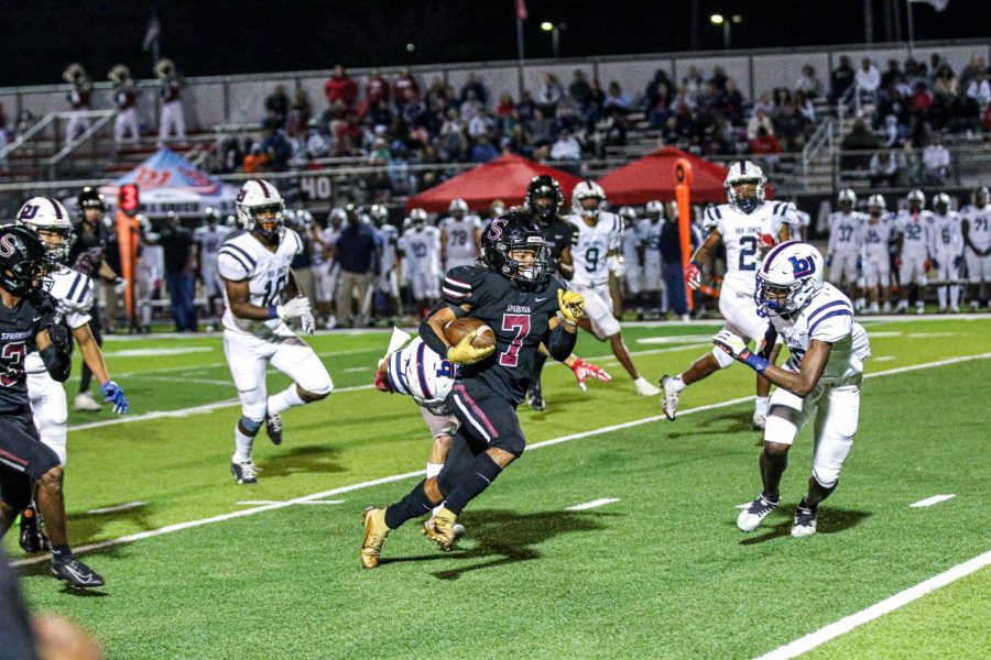 Jayden Drip Thomas  runs through the Bob Jones players, scoring a touchdown to raise the teams score.