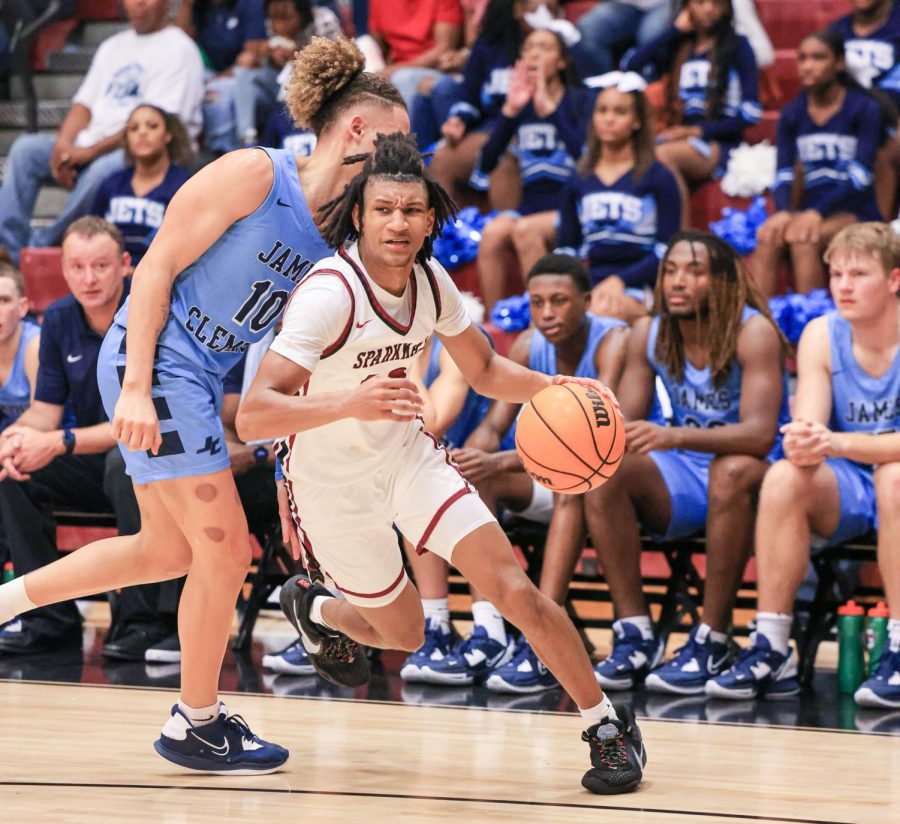 Senior Cam Jones dribbles past a James Clemens defender. The team opened against the Jets on Nov. 8. 