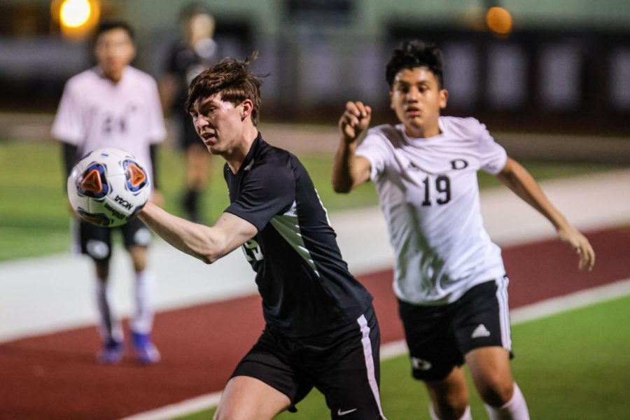 In last years game against 5A Decatur, senior Walt Echols takes the ball up the field. 