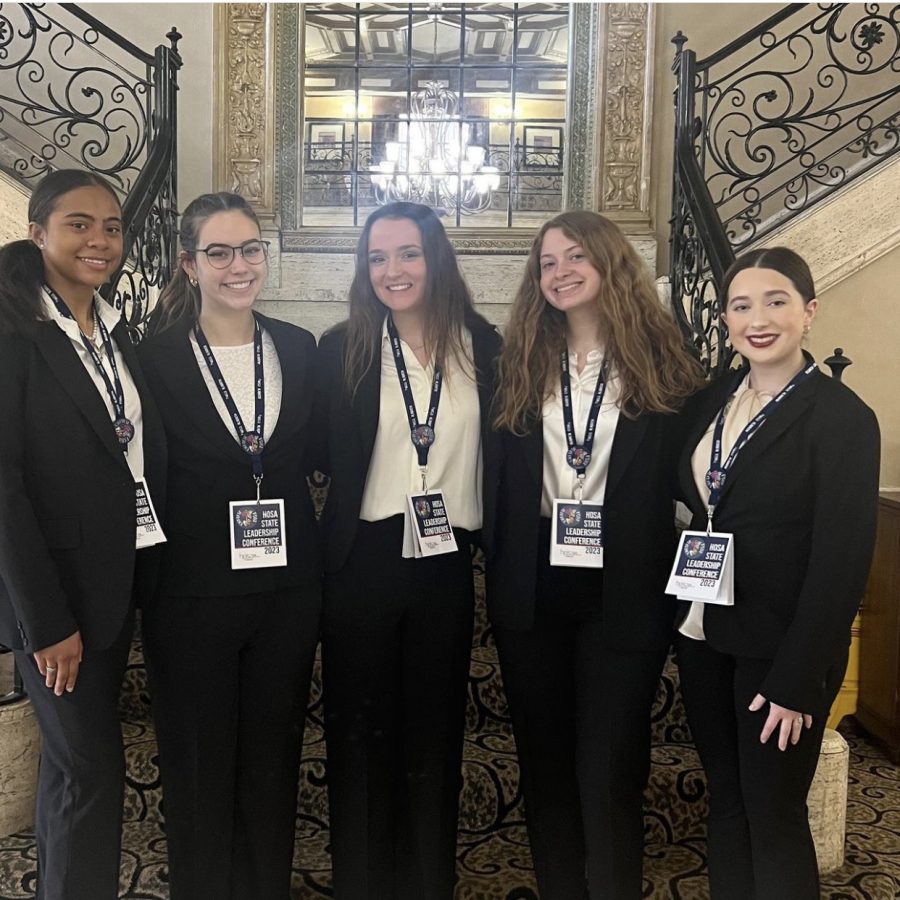 Members of HOSA gather together  to pose for a group photo.