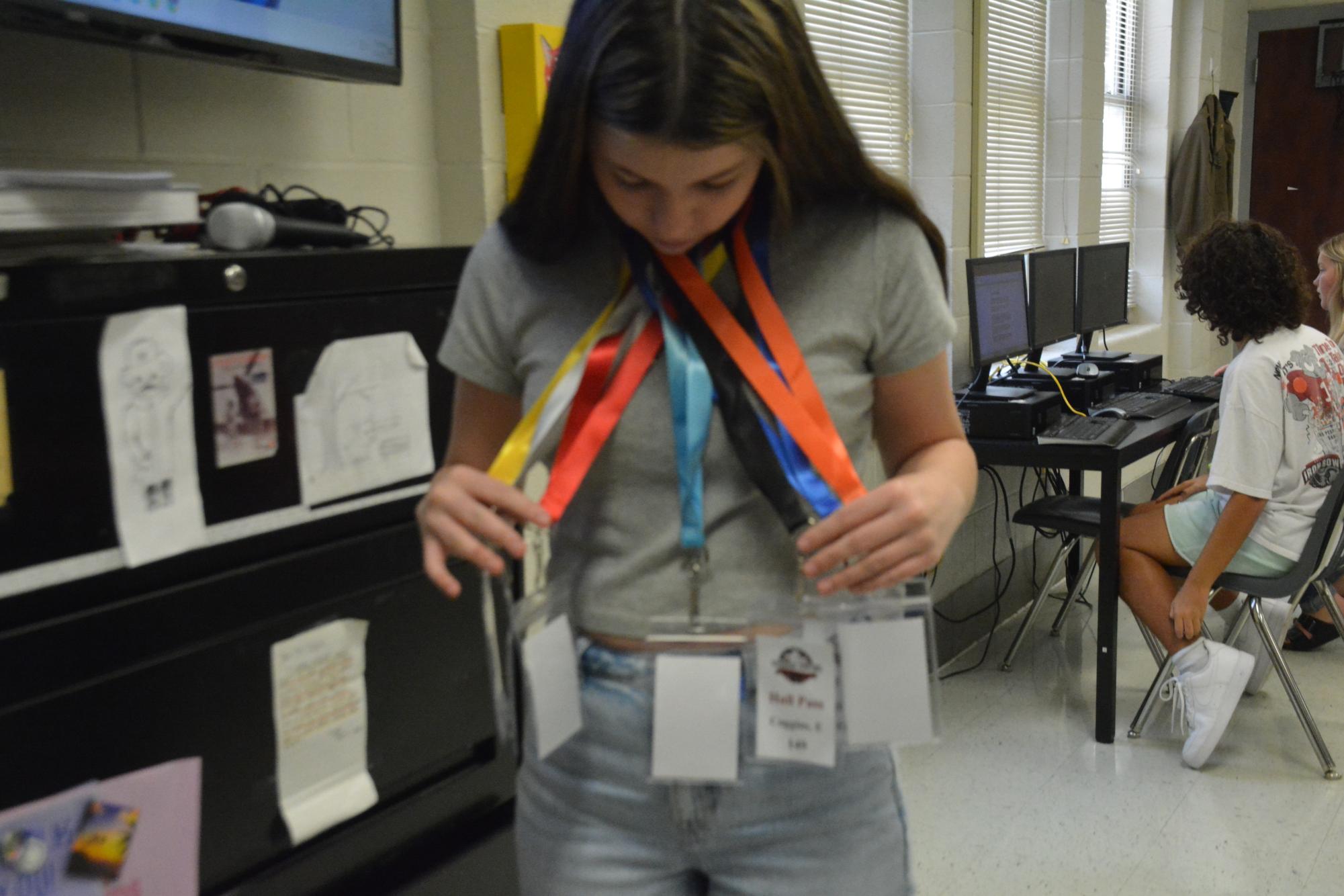 Sophomore Hannah Derreberry chooses which pass she needs to go to the guidance office. Derreberry was showing to the class how complicated the new system is until you learn what colors to to what part of the building. 