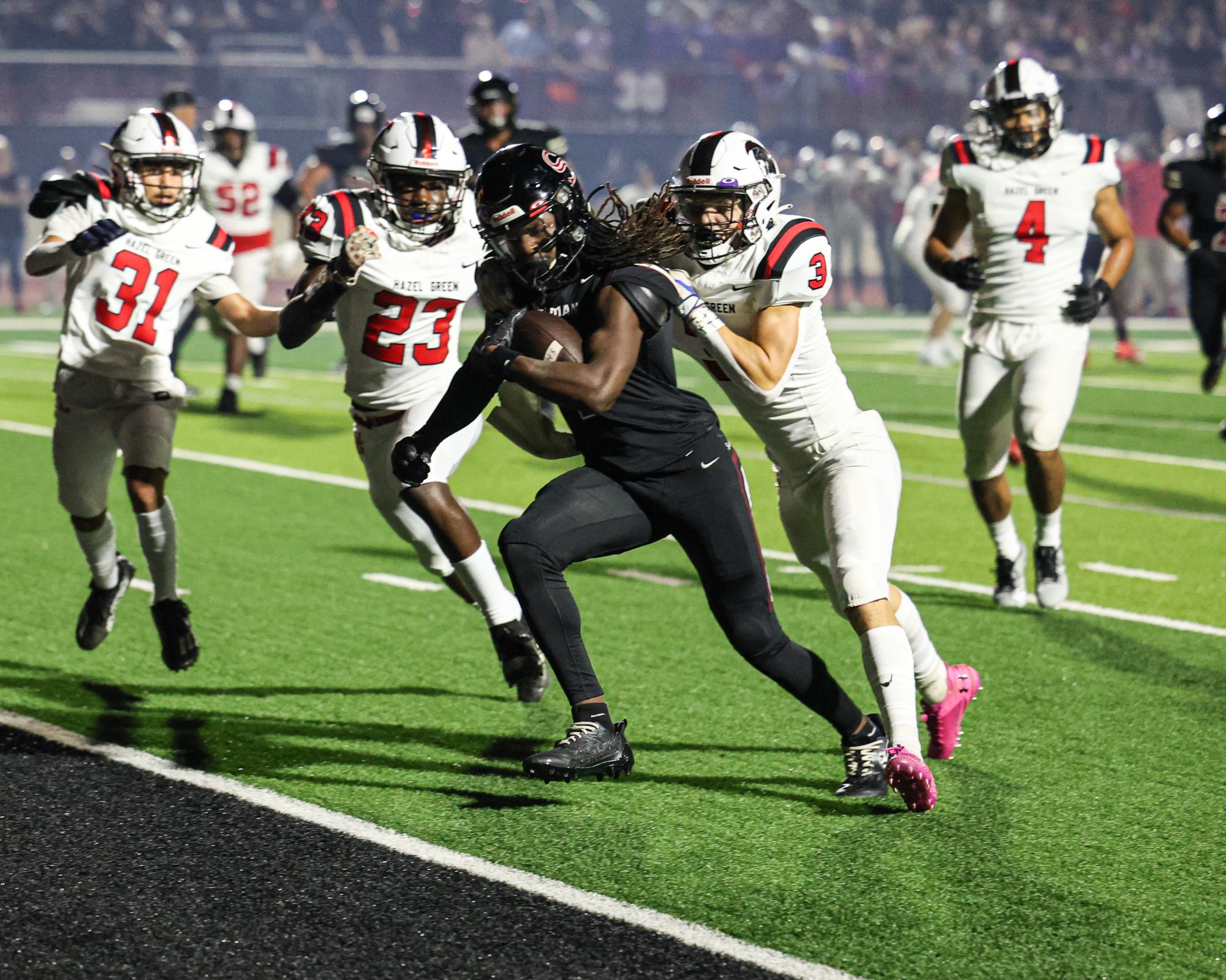 With a Hazel Green defender hanging on, junior Jon Rozier crosses into the end zone. Rozier scored the first touchdown in the game. 
