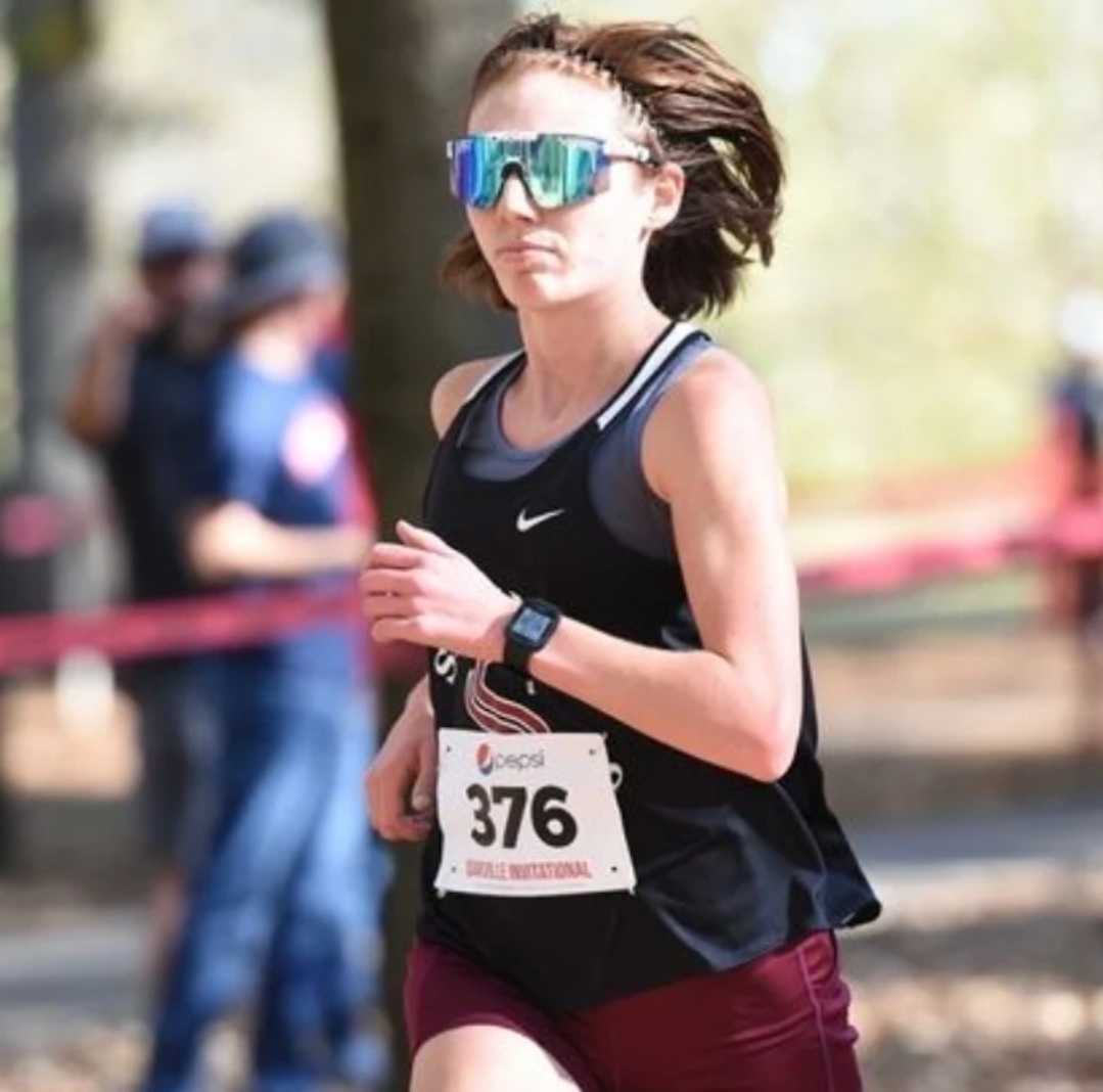 Running a recent race, senior Sam Menikheim races to the finish line.