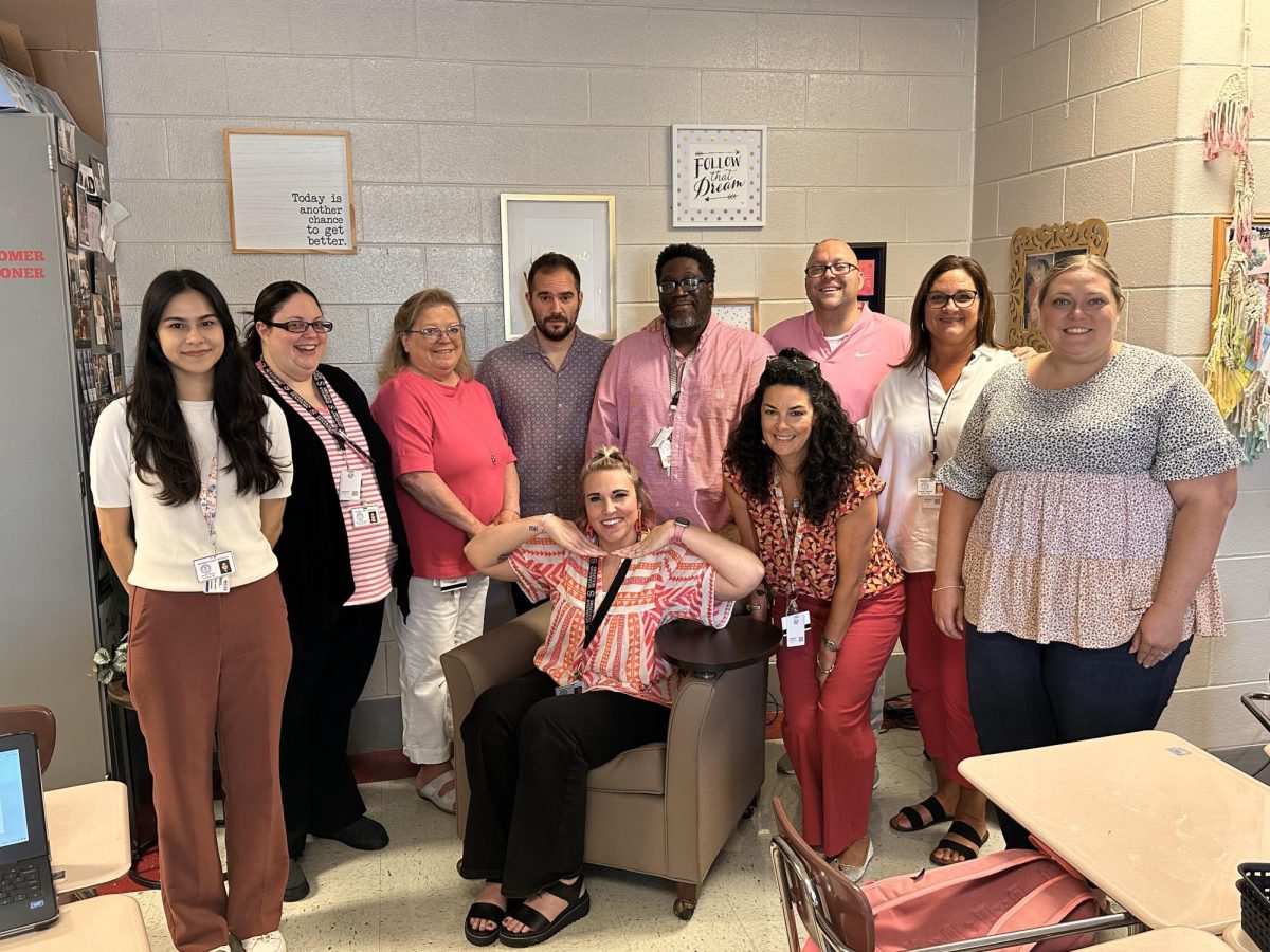 Multiple teachers pose with Mrs. Johnston showing their support by wearing pink on Wednesdays.
