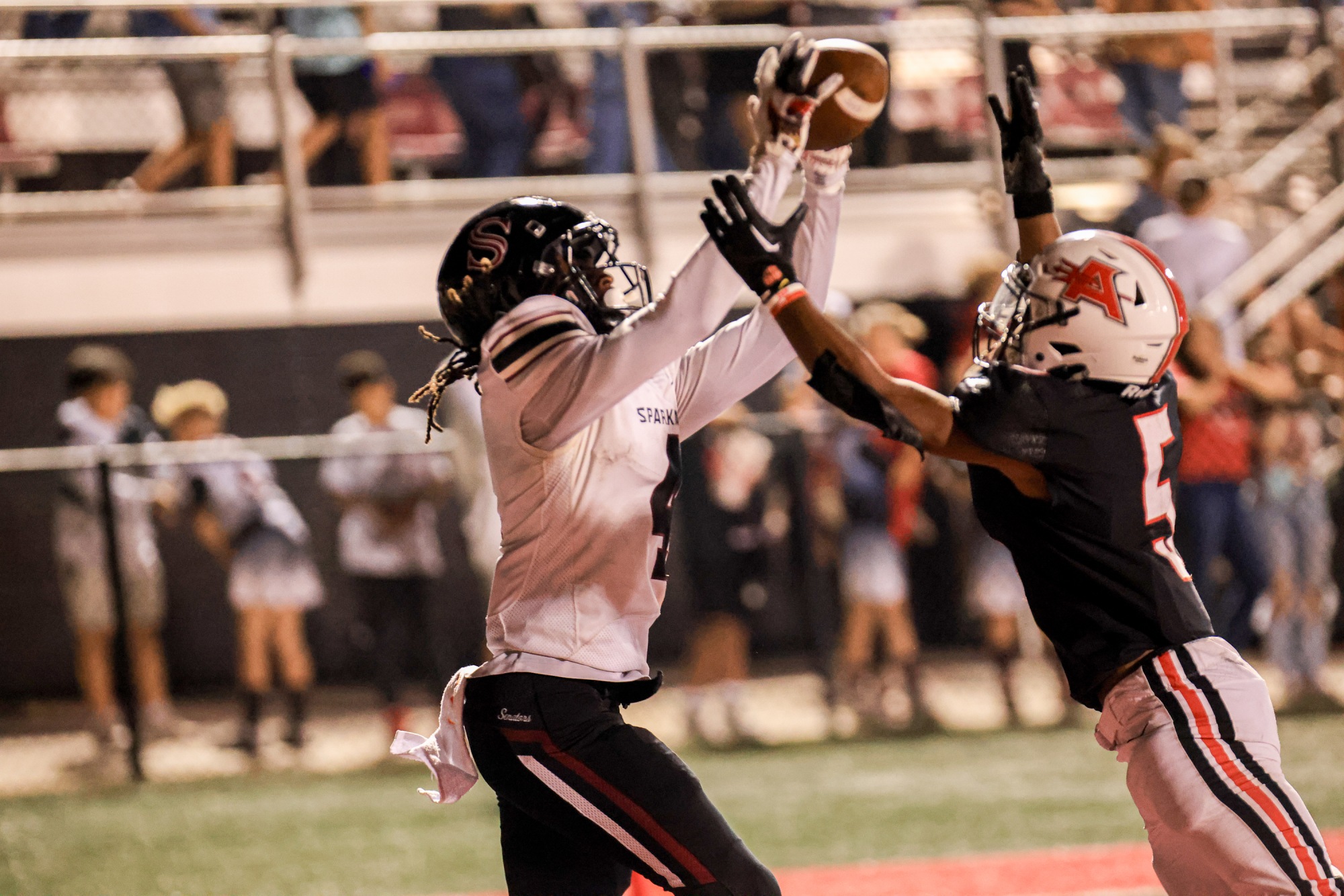 Snatching the ball from the air, junior Jonathan Rozier catches a pass from QB Jaiden Scott to score one of two touchdowns for the night. The offense put on a clinic with a 58-0 win over Albertville. 